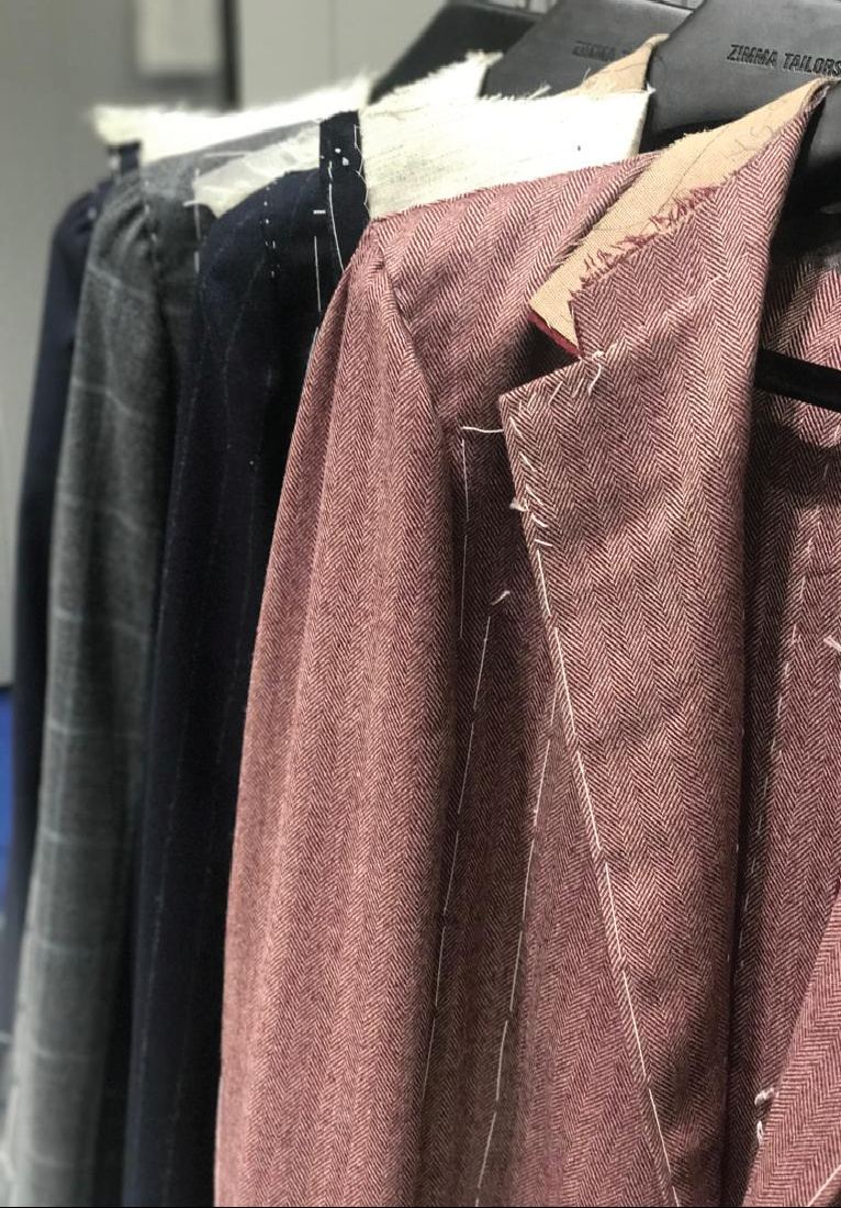 Basted jackets on the rail at Zimma Tailors